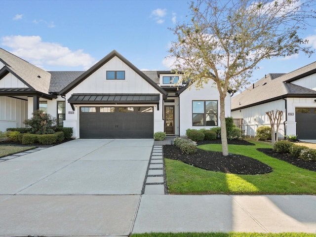 11715 Tranquility Summit Dr, Cypress, TX 77433 - modern farmhouse featuring board and batten siding, a garage, driveway, a front lawn, and a standing seam roof