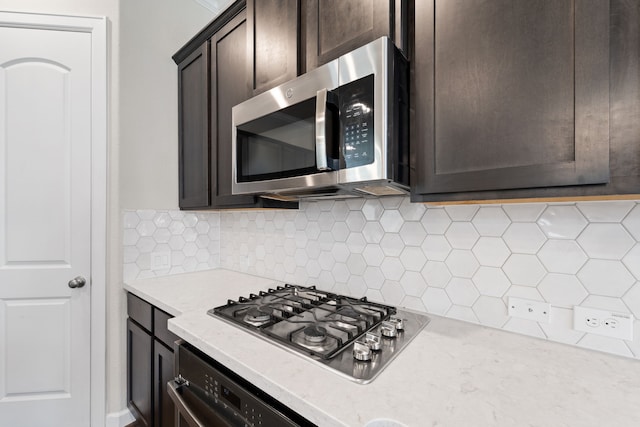 11909 Eastgrove Park Way, Houston, TX 77051 - kitchen with appliances with stainless steel finishes, dark brown cabinets, and decorative backsplash