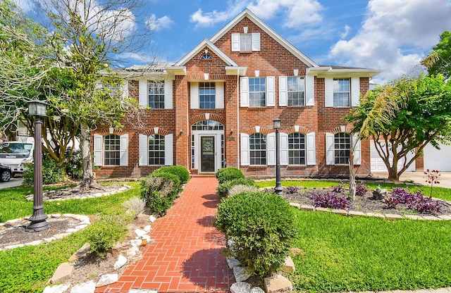 19711 Arbor Creek Dr, Katy, TX 77449 - colonial inspired home with brick siding and a front lawn