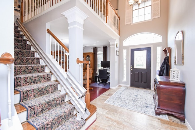 19711 Arbor Creek Dr, Katy, TX 77449 - entryway featuring decorative columns, stairway, a high ceiling, wood finished floors, and baseboards