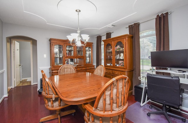 19711 Arbor Creek Dr, Katy, TX 77449 - dining area featuring a chandelier, arched walkways, dark wood-type flooring, and baseboards