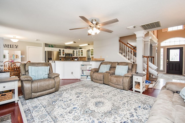 19711 Arbor Creek Dr, Katy, TX 77449 - living area featuring a ceiling fan, stairs, wood finished floors, and ornate columns