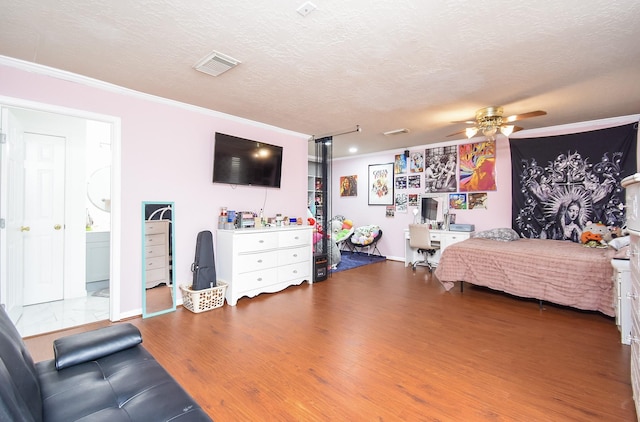 19711 Arbor Creek Dr, Katy, TX 77449 - bedroom featuring ornamental molding, wood finished floors, a textured ceiling, and baseboards