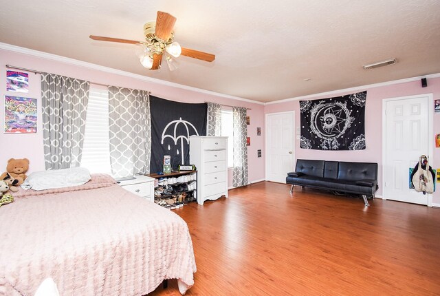 19711 Arbor Creek Dr, Katy, TX 77449 - bedroom with wood finished floors, ornamental molding, ceiling fan, and baseboards