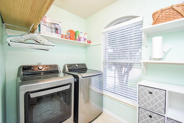 19711 Arbor Creek Dr, Katy, TX 77449 - washroom with washing machine and clothes dryer, healthy amount of natural light, and baseboards
