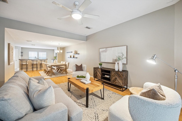 1244 W 18th St, Houston, TX 77008 - living room with light wood-style floors, a chandelier, and ceiling fan