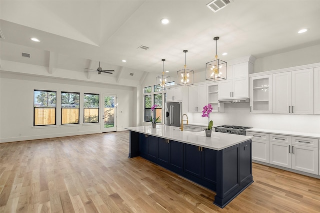 1038 W 31st St, Houston, TX 77018 - kitchen featuring high quality fridge, recessed lighting, vaulted ceiling, white cabinetry, and light countertops