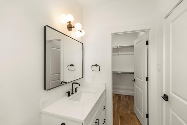 1038 W 31st St, Houston, TX 77018 - bathroom with vanity, wood finished floors, and a walk in closet