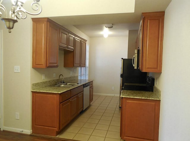 kitchen with a sink, appliances with stainless steel finishes, baseboards, a chandelier, and light tile patterned floors