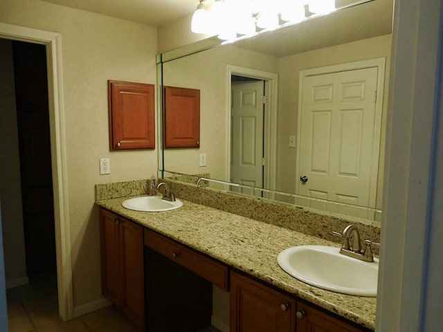 full bathroom featuring double vanity, tile patterned floors, and baseboards