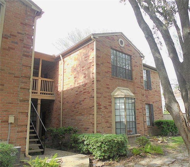 view of side of home with brick siding