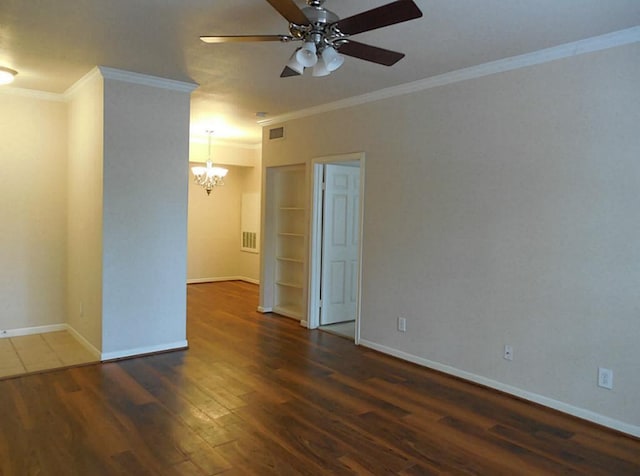 empty room with a chandelier, a ceiling fan, wood finished floors, crown molding, and baseboards