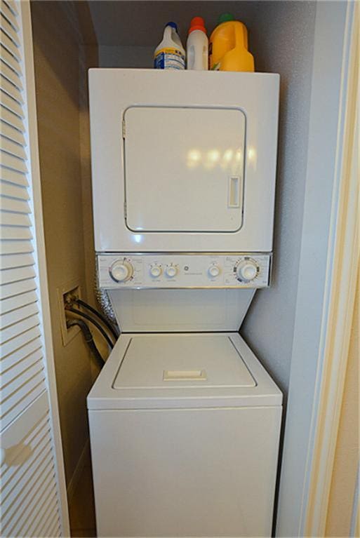 laundry area featuring stacked washer / dryer