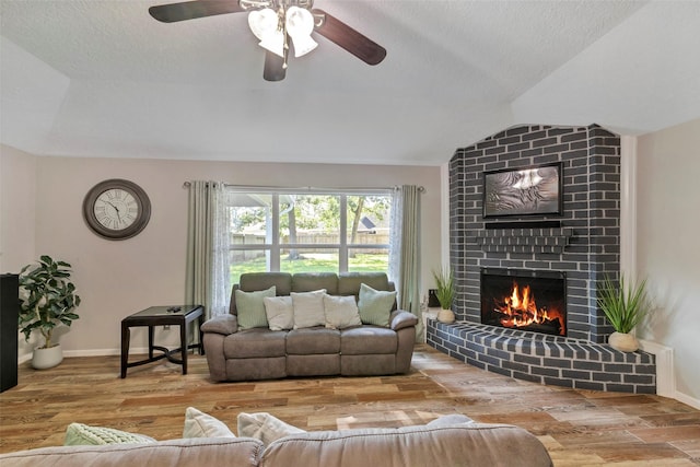 710 Razee Ct, Crosby, TX 77532 - living room with lofted ceiling, a brick fireplace, wood finished floors, a ceiling fan, and baseboards
