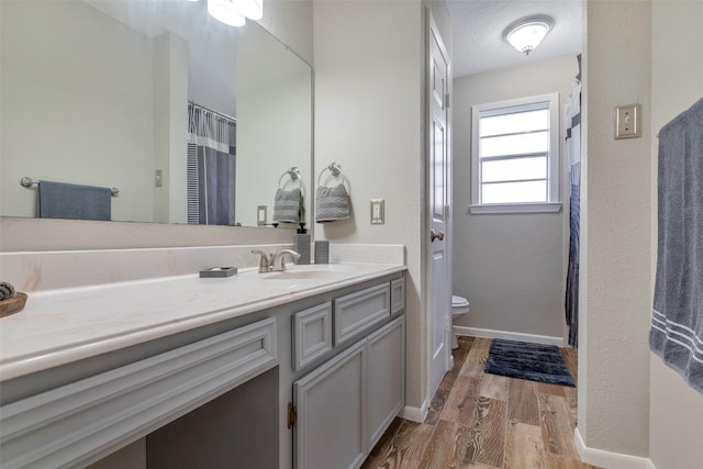 710 Razee Ct, Crosby, TX 77532 - full bath with toilet, wood finished floors, vanity, and baseboards