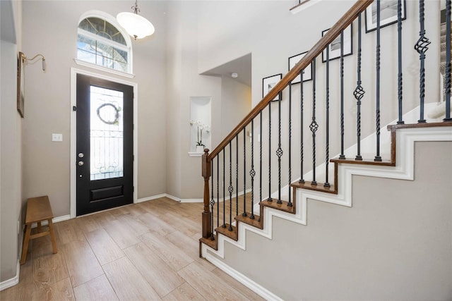 30427 Legacy Pines Dr, Spring, TX 77386 - foyer entrance featuring wood finished floors, stairs, a high ceiling, and baseboards