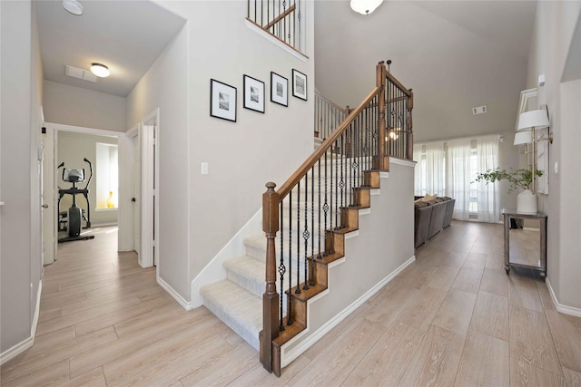 30427 Legacy Pines Dr, Spring, TX 77386 - stairway with wood finished floors, baseboards, and a towering ceiling