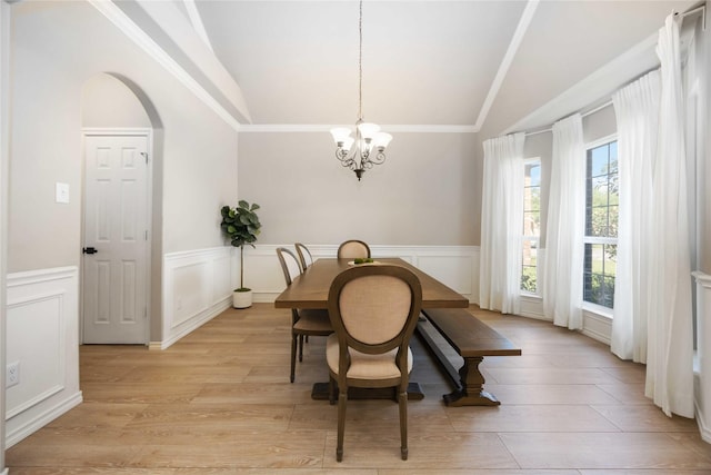 30427 Legacy Pines Dr, Spring, TX 77386 - dining room featuring vaulted ceiling, a chandelier, arched walkways, wainscoting, and light wood-style flooring