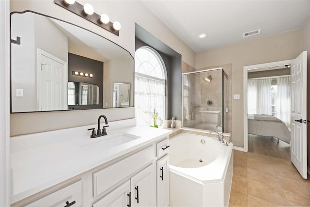 30427 Legacy Pines Dr, Spring, TX 77386 - ensuite bathroom featuring a shower stall, a jetted tub, vanity, and tile patterned flooring
