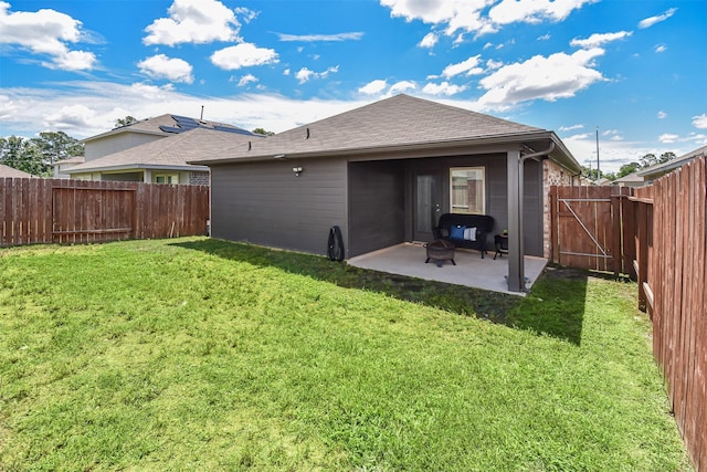 back of property featuring a patio area and a gate