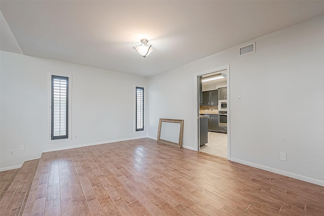 5723 Jason St, Houston, TX 77096 - spare room with light wood-type flooring, plenty of natural light, and baseboards
