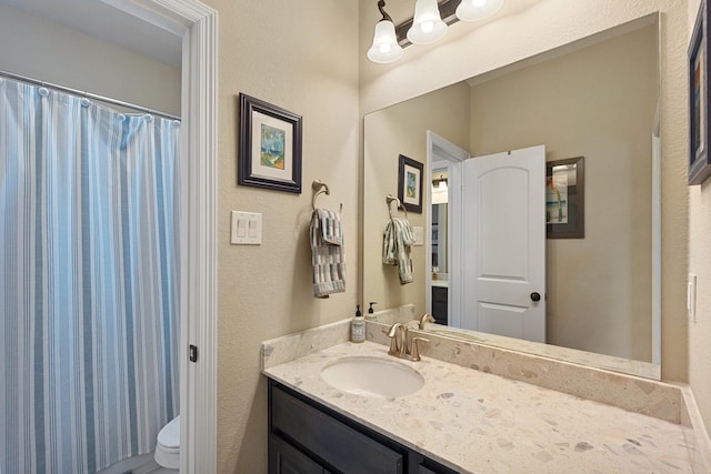 5131 Rowley Falls Ln, Sugar Land, TX 77479 - full bathroom featuring toilet, vanity, a shower with curtain, and a textured wall