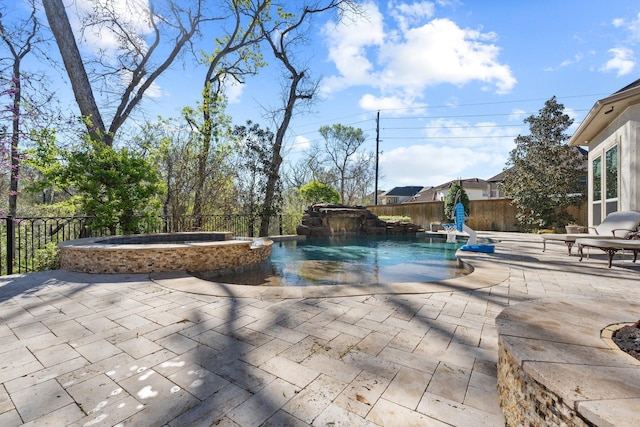 5131 Rowley Falls Ln, Sugar Land, TX 77479 - view of swimming pool featuring a pool with connected hot tub, a fenced backyard, and a patio