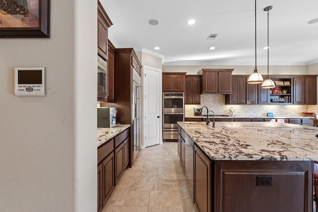 5131 Rowley Falls Ln, Sugar Land, TX 77479 - kitchen with appliances with stainless steel finishes, crown molding, tasteful backsplash, light stone finish flooring, and an island with sink