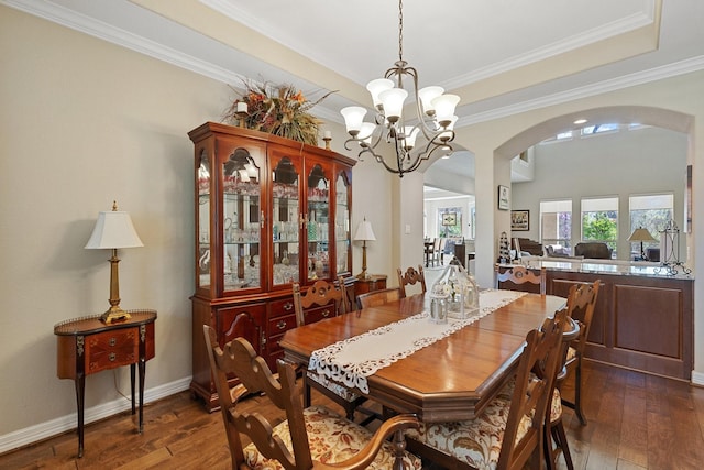 5131 Rowley Falls Ln, Sugar Land, TX 77479 - dining area featuring arched walkways, dark wood-style floors, a chandelier, crown molding, and baseboards