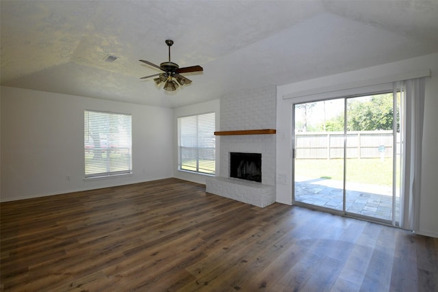 18811 Pine Trace Ct, Humble, TX 77346 - unfurnished living room featuring dark wood-type flooring, a ceiling fan, vaulted ceiling, and a fireplace