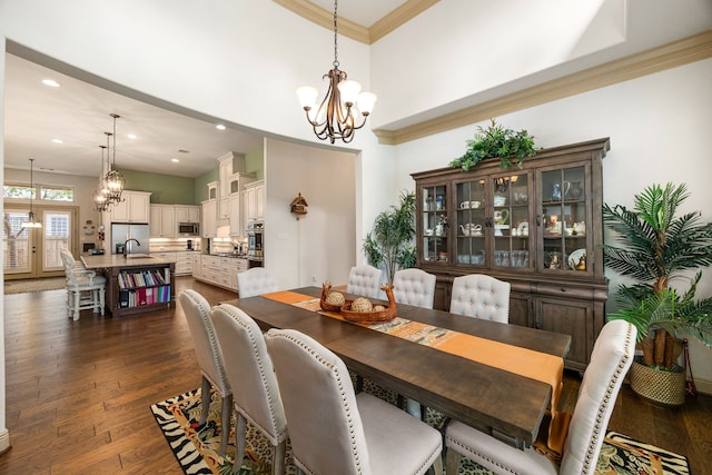 1223 Eversham Way, Kingwood, TX 77339 - dining area featuring a chandelier, dark wood-style floors, recessed lighting, crown molding, and a towering ceiling