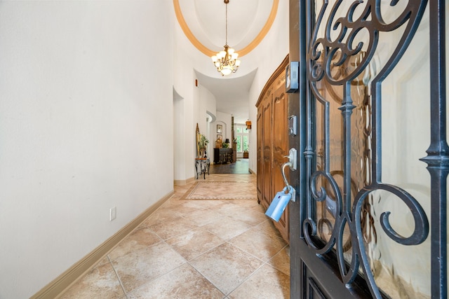 1223 Eversham Way, Kingwood, TX 77339 - entrance foyer with a chandelier, baseboards, a towering ceiling, and light stone finish floors