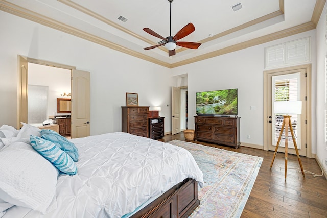 1223 Eversham Way, Kingwood, TX 77339 - bedroom featuring a tray ceiling, ornamental molding, wood finished floors, ceiling fan, and ensuite bath
