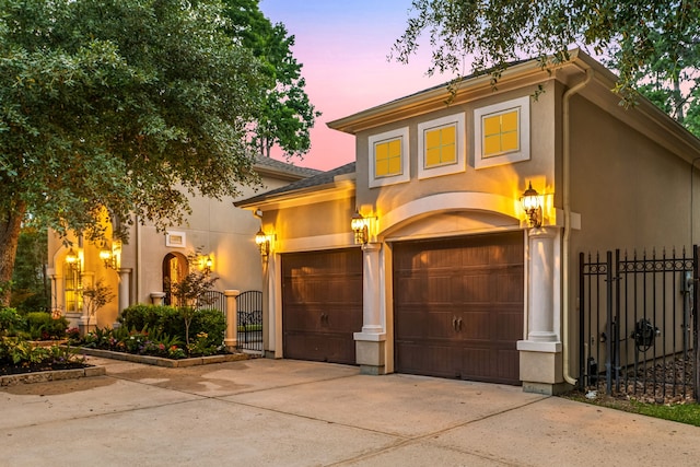 1223 Eversham Way, Kingwood, TX 77339 - view of front of house with driveway, a gate, stucco siding, and an attached garage