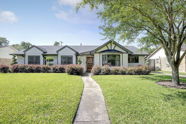 5623 Spellman Rd, Houston, TX 77096 - view of front facade with a front yard, roof with shingles, and brick siding