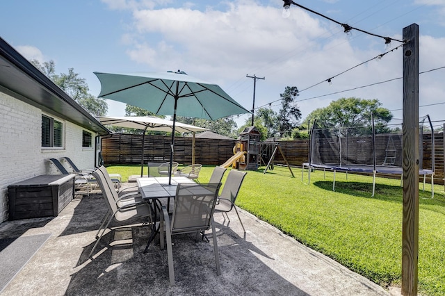 5623 Spellman Rd, Houston, TX 77096 - view of patio / terrace featuring a trampoline, outdoor dining area, and a playground