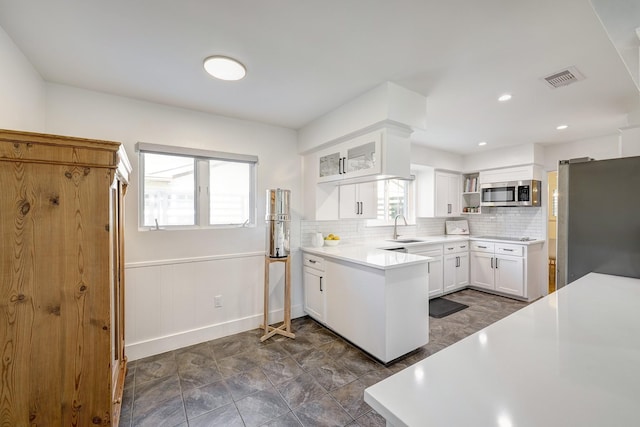 5623 Spellman Rd, Houston, TX 77096 - kitchen with appliances with stainless steel finishes, open shelves, a sink, white cabinets, and decorative backsplash