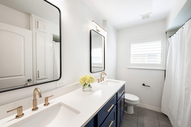 5623 Spellman Rd, Houston, TX 77096 - full bathroom with tile patterned flooring, toilet, and double vanity