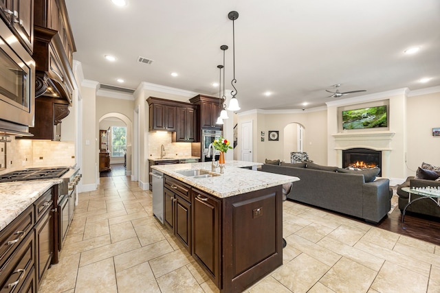 4302 Meyerwood Dr, Houston, TX 77096 - kitchen with a sink, arched walkways, a ceiling fan, open floor plan, and appliances with stainless steel finishes