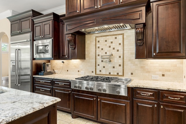 4302 Meyerwood Dr, Houston, TX 77096 - kitchen featuring built in appliances, backsplash, dark brown cabinets, premium range hood, and ornamental molding