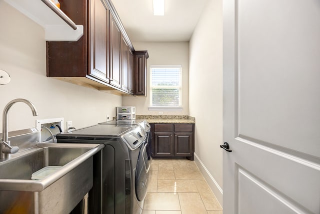 4302 Meyerwood Dr, Houston, TX 77096 - laundry area featuring washer and dryer, cabinet space, light tile patterned floors, and baseboards