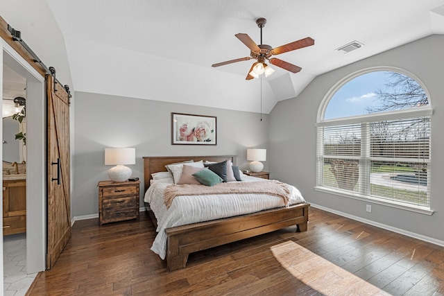 7903 Black Horse Cv, Missouri City, TX 77459 - bedroom with a barn door, vaulted ceiling, hardwood / wood-style flooring, baseboards, and ceiling fan