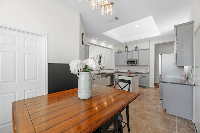 7903 Black Horse Cv, Missouri City, TX 77459 - dining area with a raised ceiling, a chandelier, a skylight, baseboards, and recessed lighting