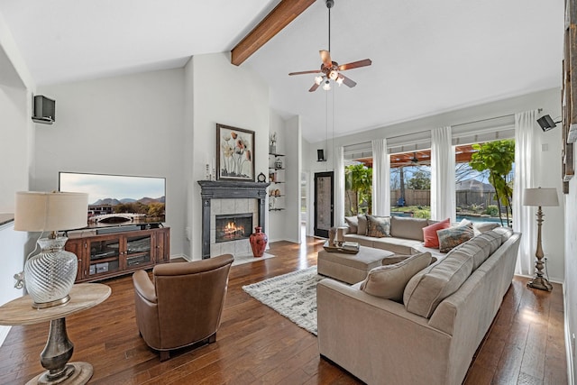 7903 Black Horse Cv, Missouri City, TX 77459 - living room with a ceiling fan, beam ceiling, dark wood finished floors, a tile fireplace, and high vaulted ceiling