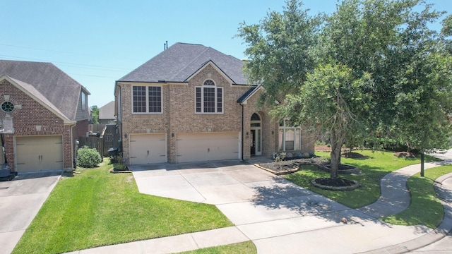 10410 Kingston Creek Ln, Cypress, TX 77433 - traditional-style home featuring concrete driveway, a front yard, an attached garage, brick siding, and a shingled roof