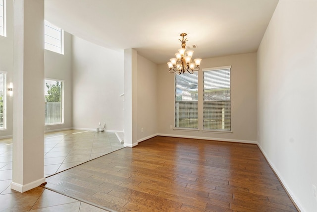 10410 Kingston Creek Ln, Cypress, TX 77433 - empty room with a chandelier, wood finished floors, and baseboards
