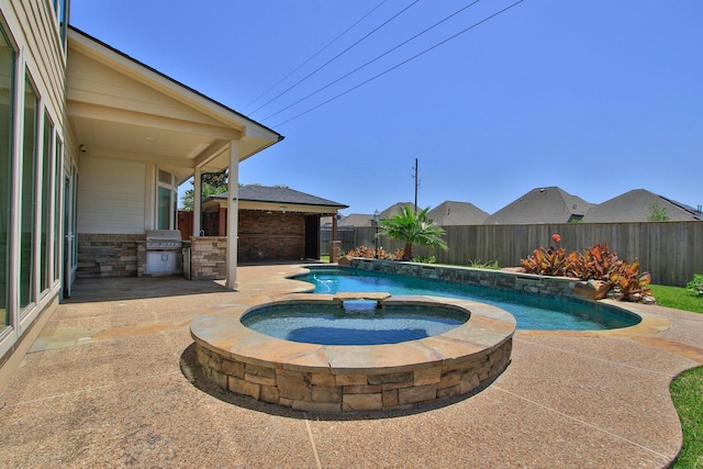10410 Kingston Creek Ln, Cypress, TX 77433 - view of pool with area for grilling, a fenced backyard, a patio, and a pool with connected hot tub