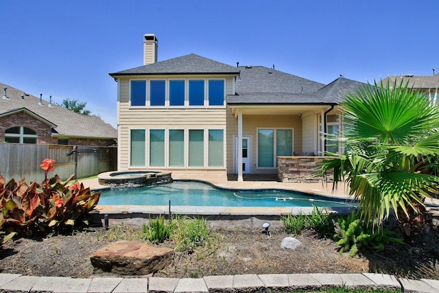 10410 Kingston Creek Ln, Cypress, TX 77433 - back of house with fence, a shingled roof, a chimney, a patio, and a pool with connected hot tub