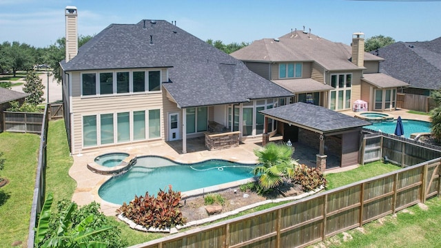 10410 Kingston Creek Ln, Cypress, TX 77433 - back of property featuring a pool with connected hot tub, a shingled roof, a chimney, and a patio area