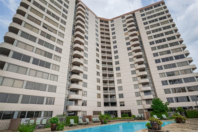 3525 Sage Rd Unit 1004, Houston, TX 77056 - view of building exterior with a community pool and fence